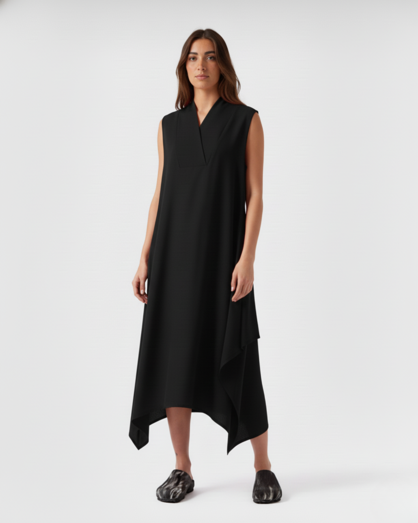 Sleeveless black linen asymmetric dress on model