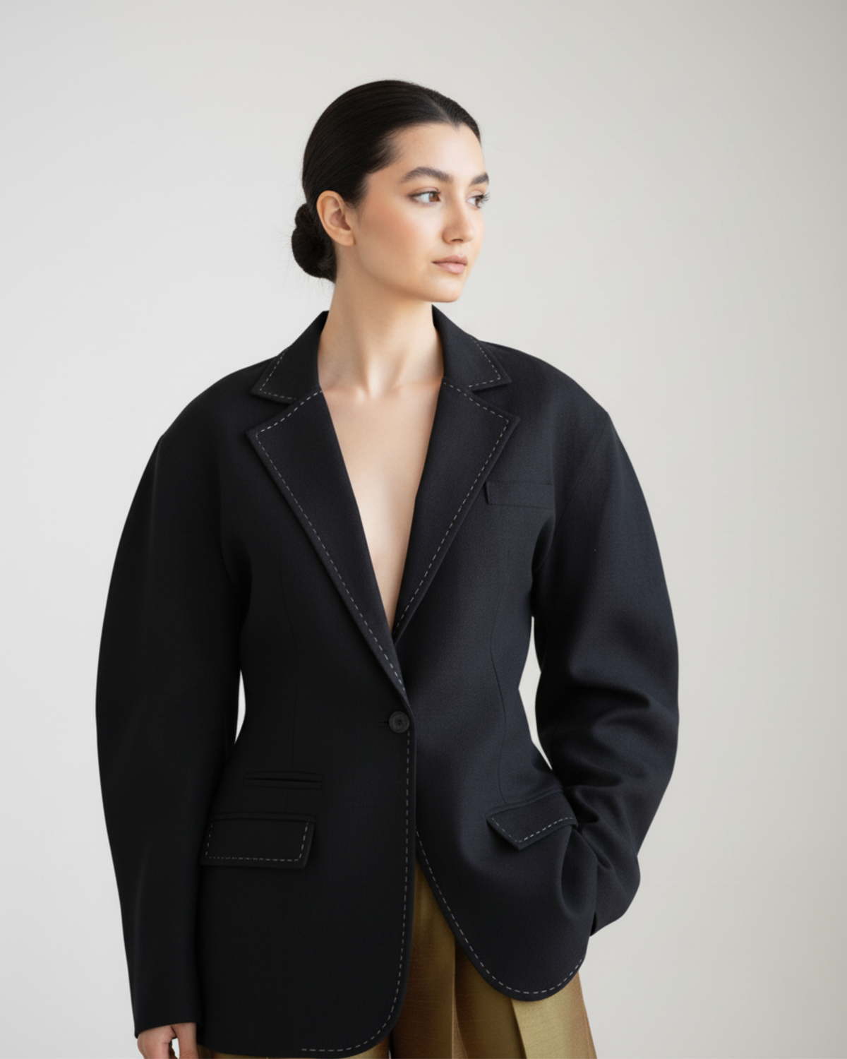 model wearing black linen blend blazer with decorative stitches