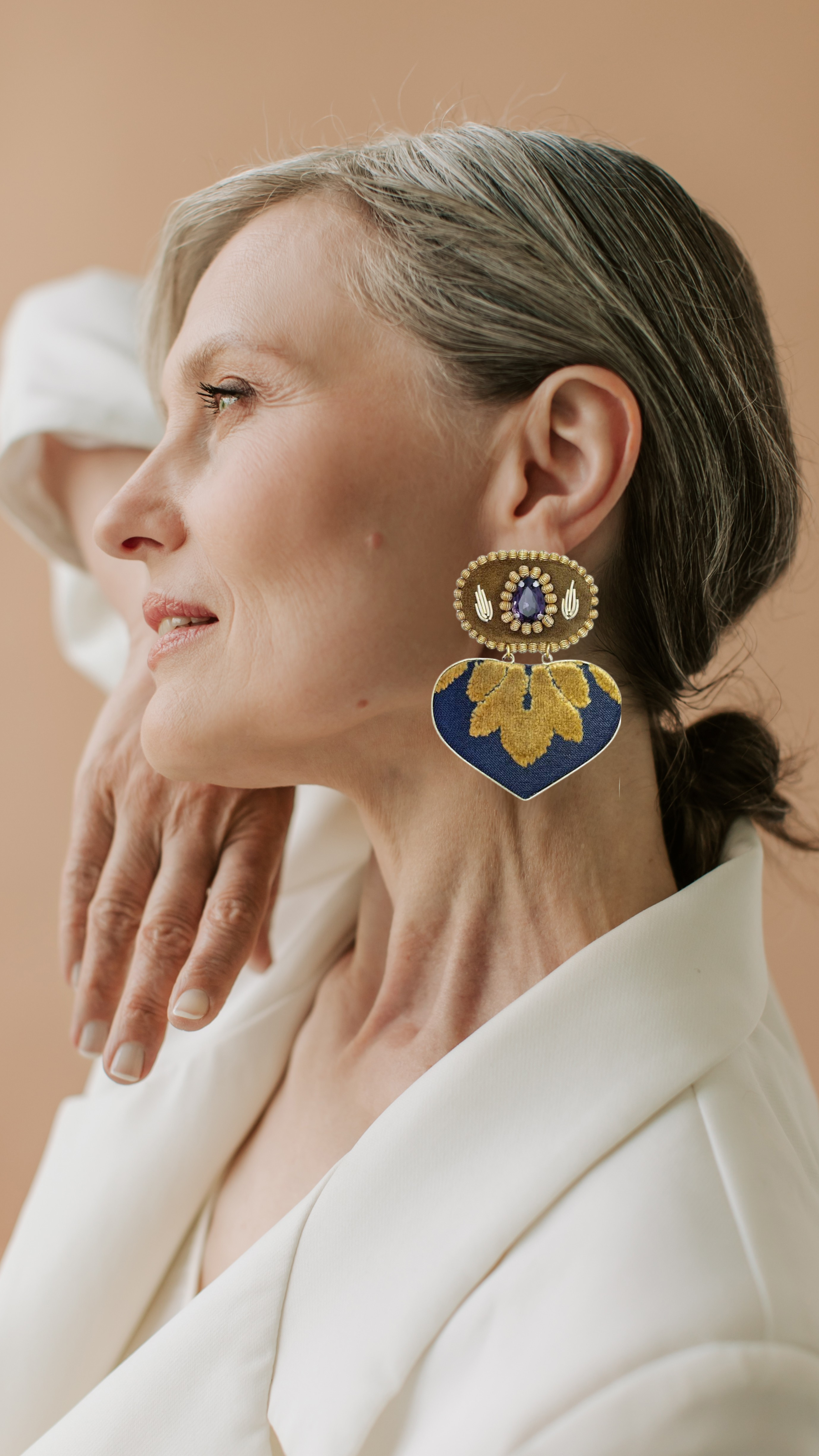Model wearing handmade statement earrings