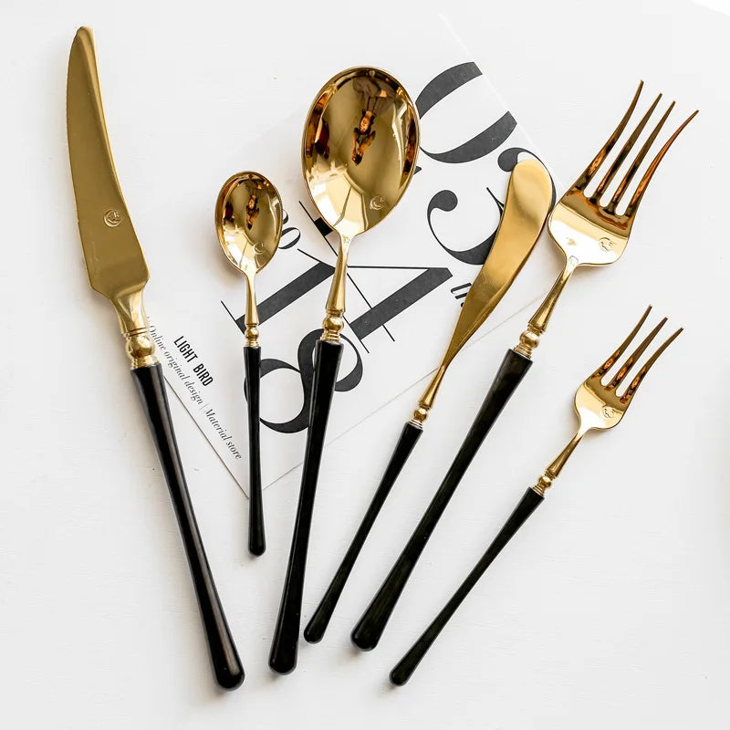 4-piece golden stainless steel flatware set with black handles