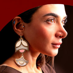 Model wearing large geometric handmade earrings with double-tier drop design