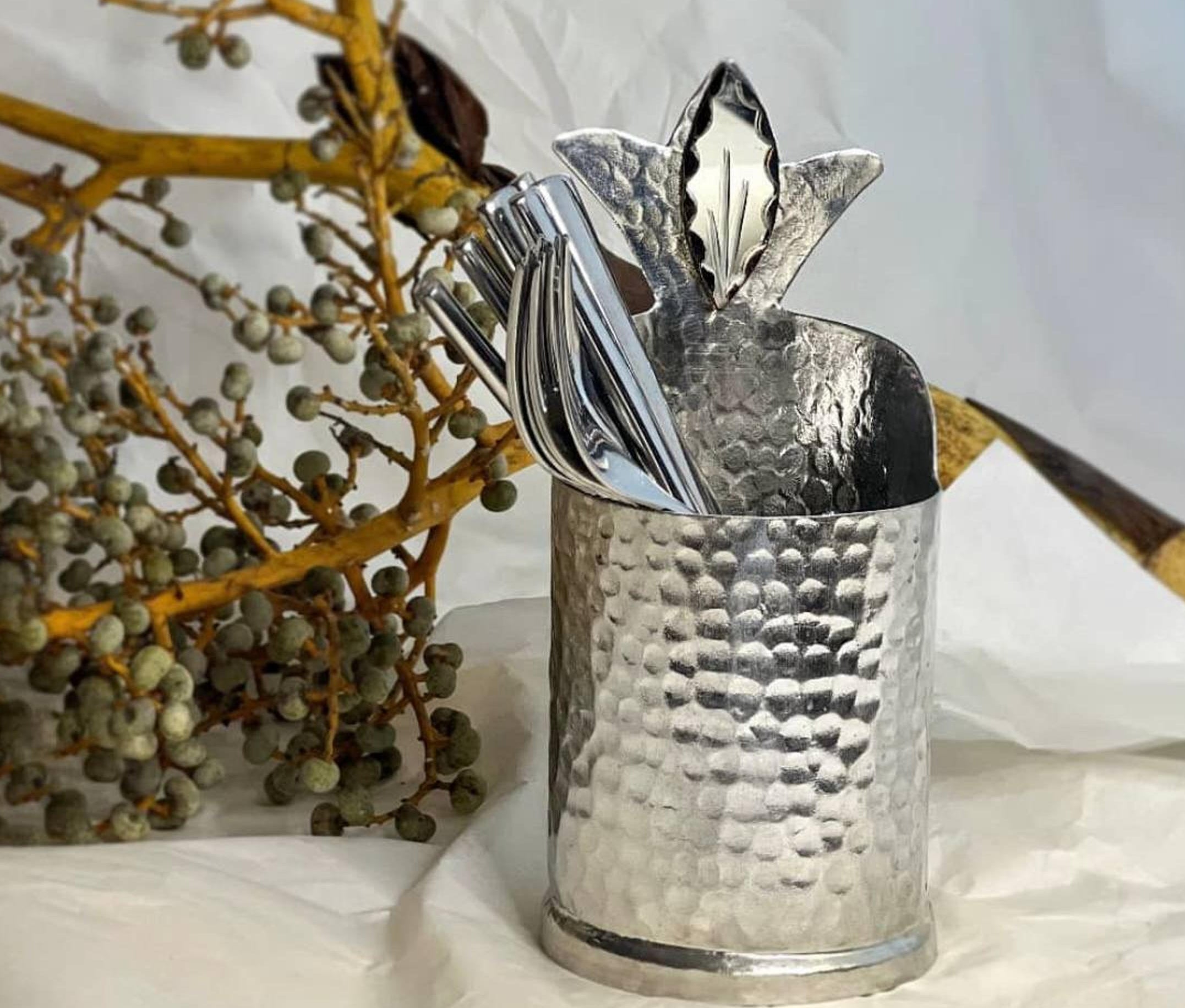 Handmade decorative utensil holder filled with cutlery 