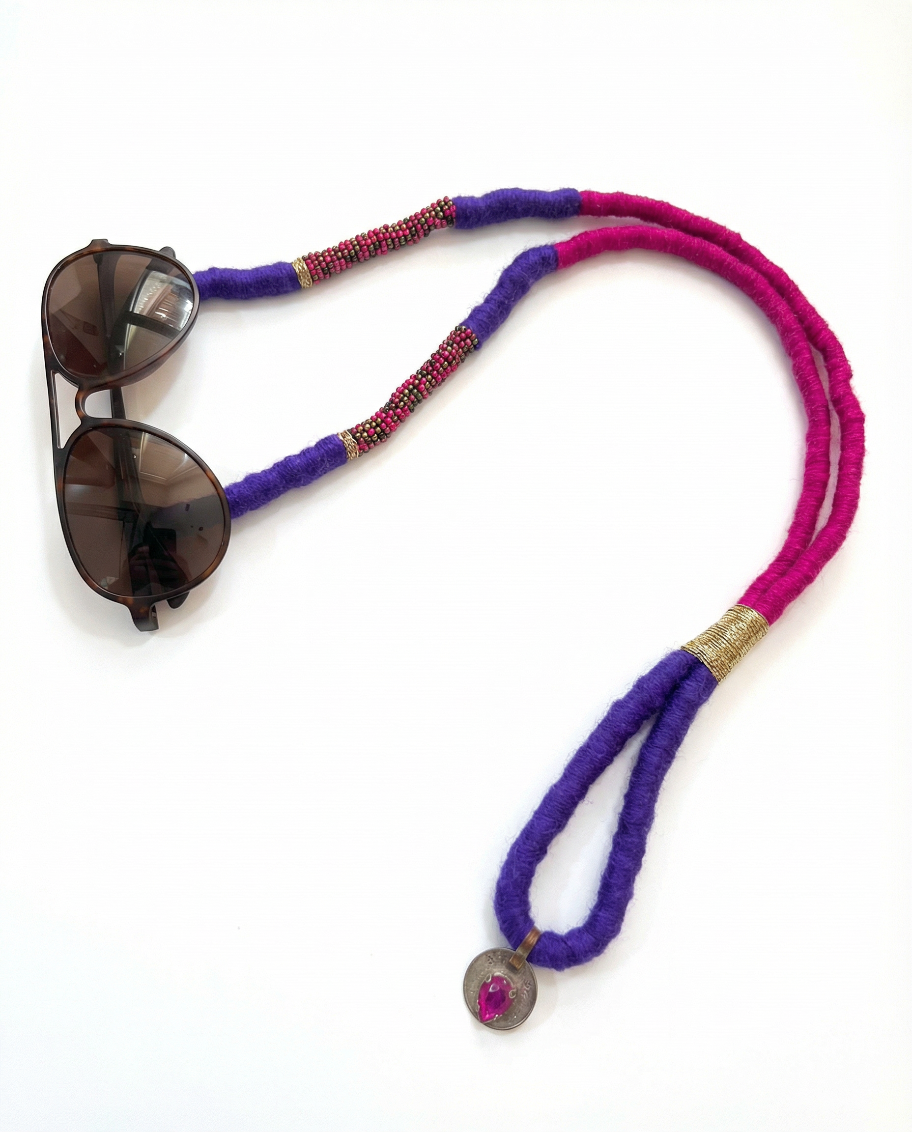 Sunglasses with a colorful beaded lanyard on a white background