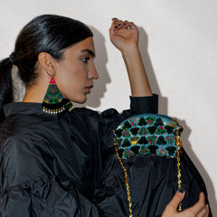 Model holding acrylic Persian inspired designer handbag