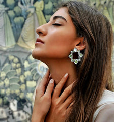 Model wearing handmade geometric mirror earrings inspired by Persian architecture