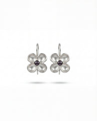 Minimalist pearl center silver earrings on neutral background