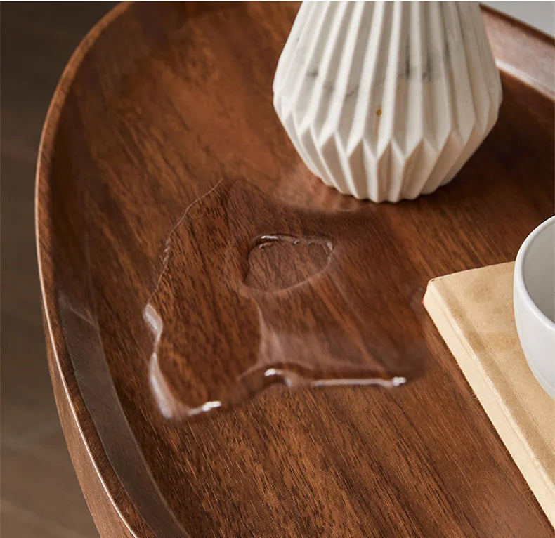 Wooden surface with a heart-shaped cutout and a white vase in the background