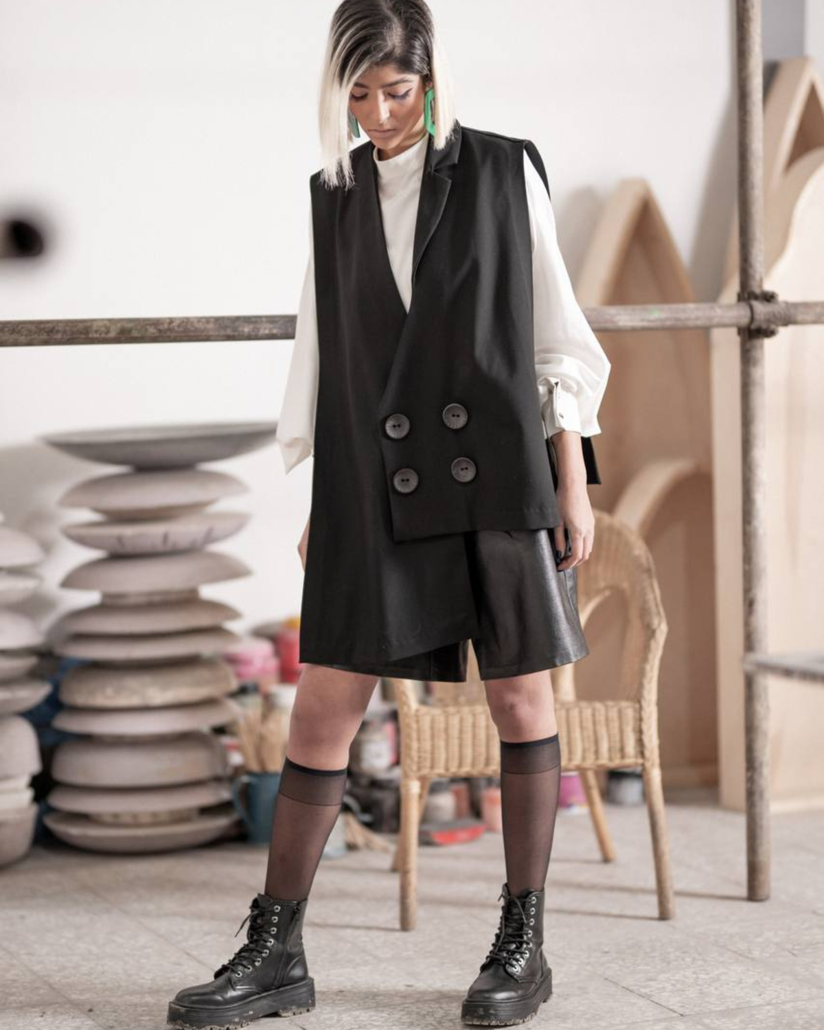 oversized black vest with large buttons and white shirt