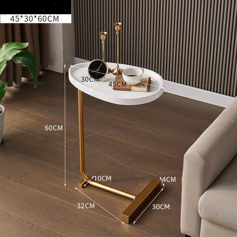 Small round table with gold legs on a wooden floor, dimensions labeled.