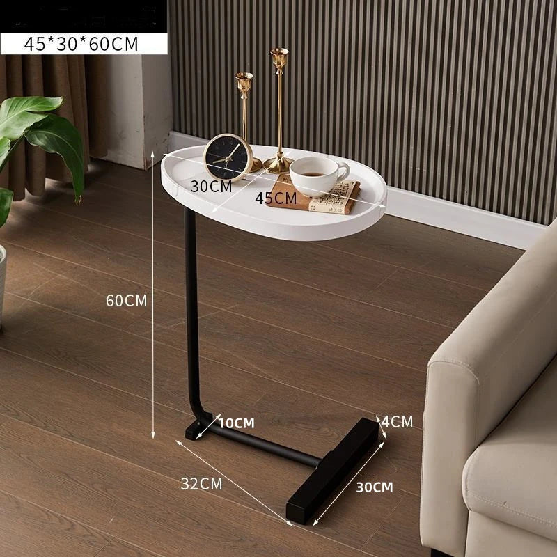Small round table with dimensions labeled on a wooden floor next to a sofa.