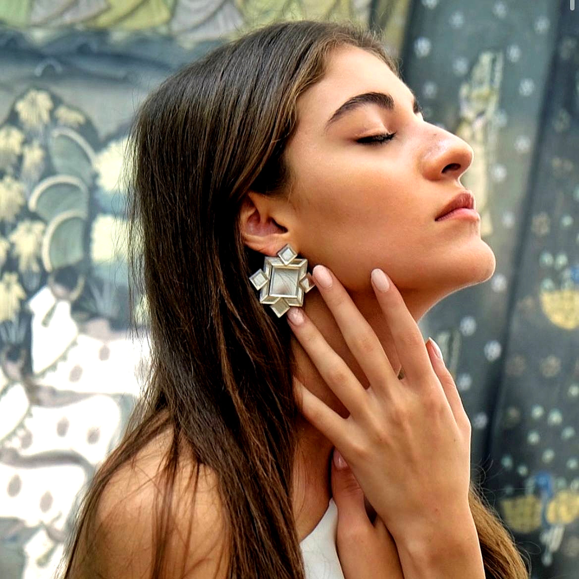 Model wearing handmade geometric mirror earrings