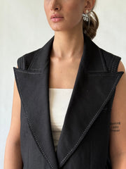  details of sleeveless blazer with decorative stitch accents