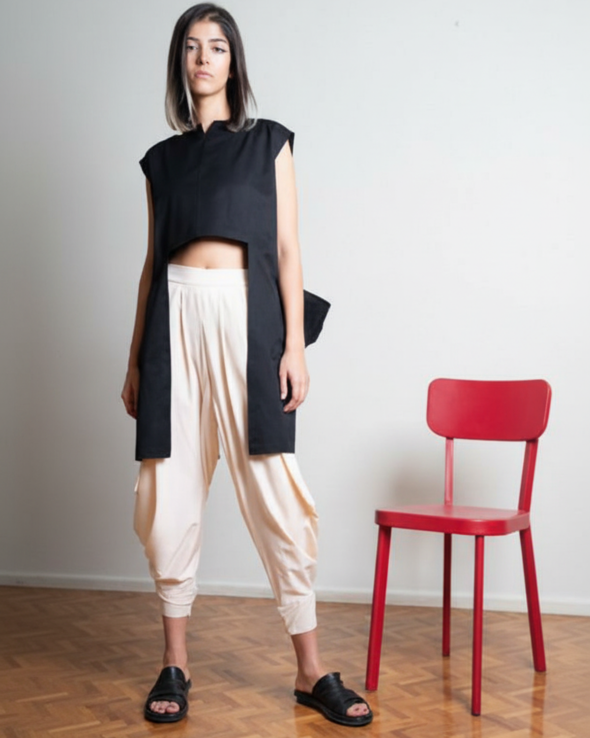 Model wearing structured black sleeveless top with open front