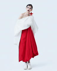 White linen asymmetrical blouse styled off-shoulder with red skirt