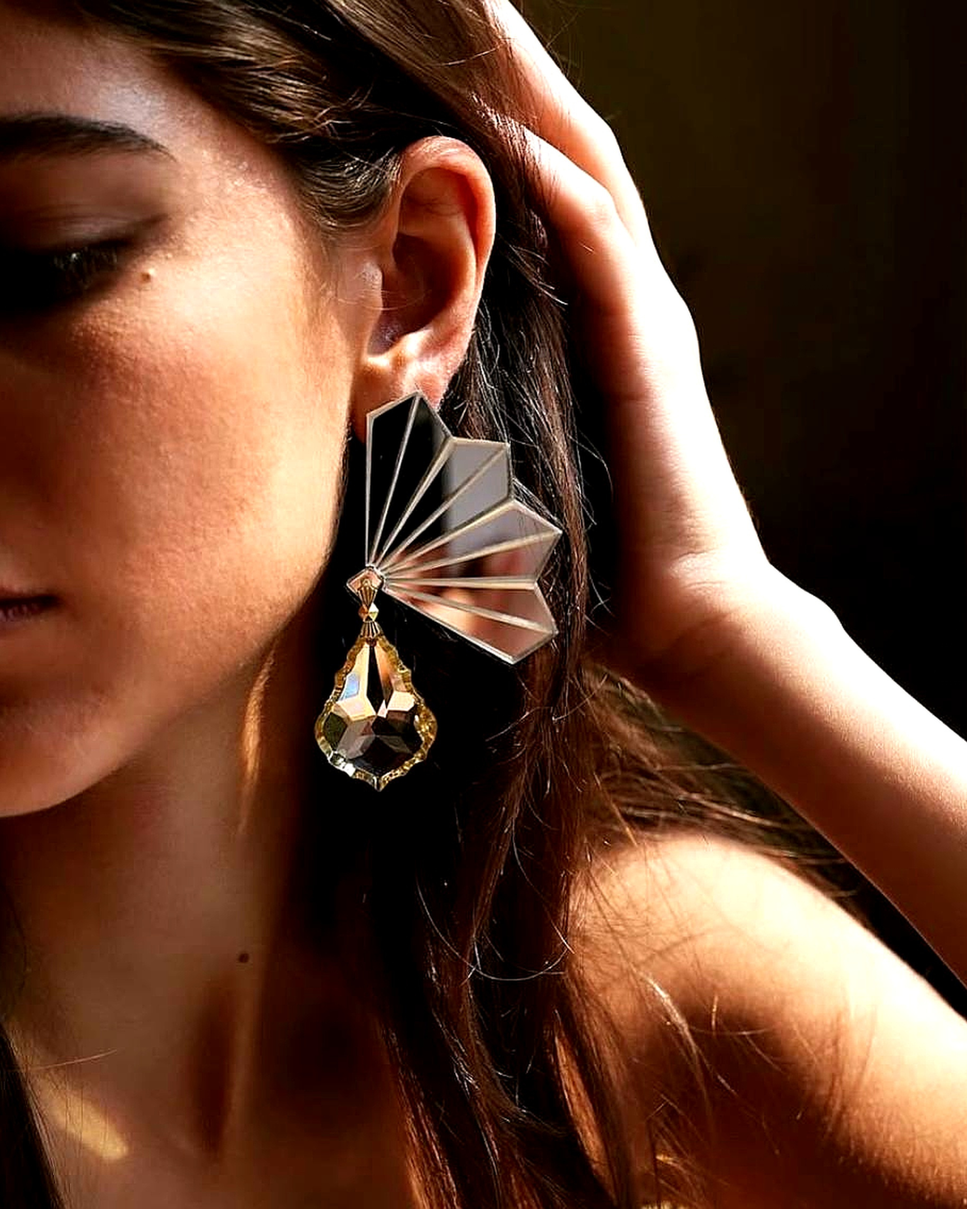 Statement plexiglass and crystal earrings reflecting ocean-inspired elegance