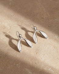 Handmade minimalist silver dangle earrings close up