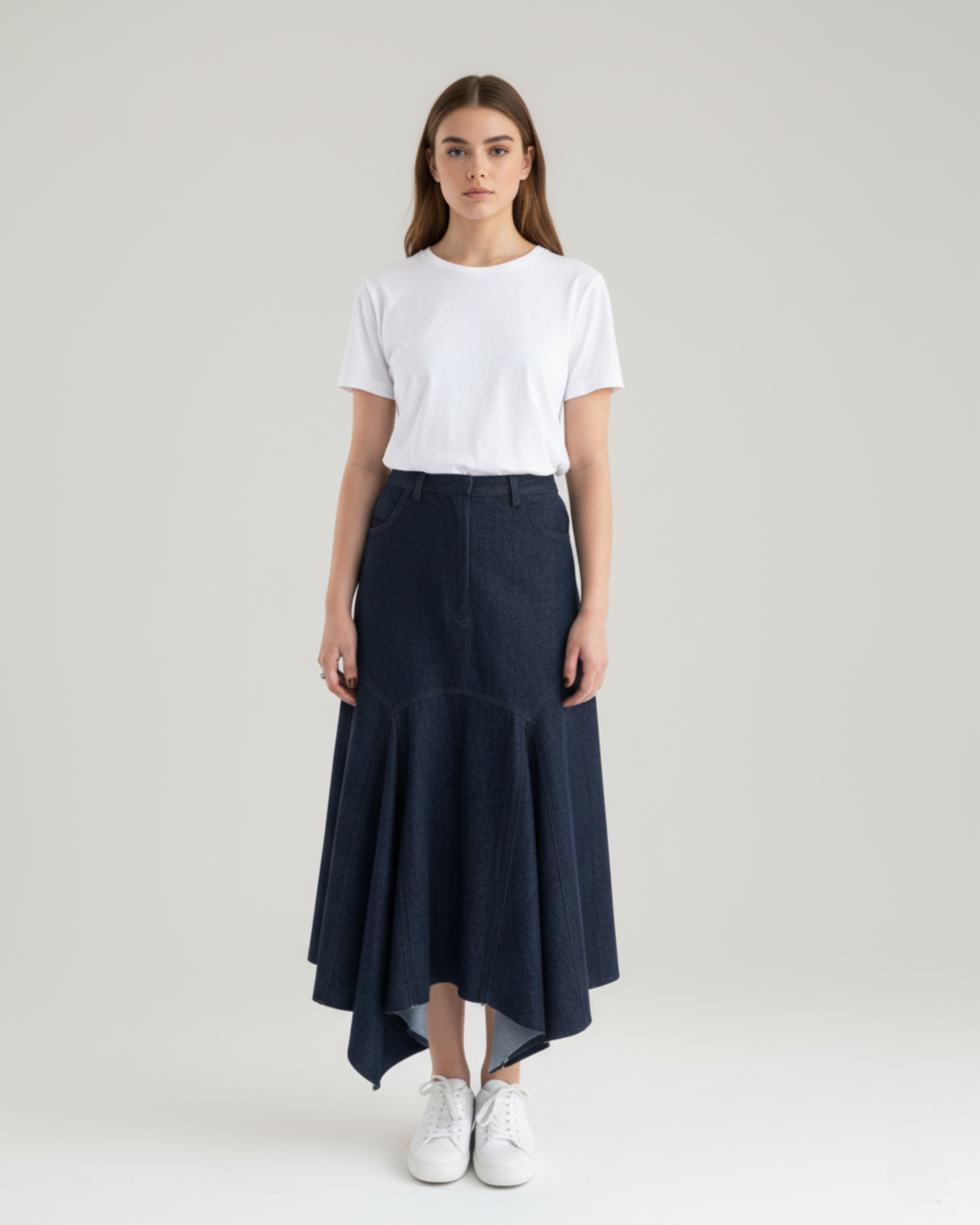 model wearing high-waist asymmetric denim midi skirt front view