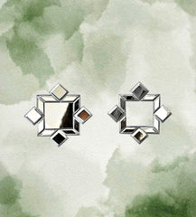 Flat-lay of handcrafted mirror earrings on watercolor background