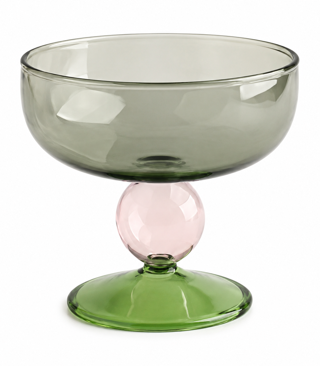 Green glass bowl with a pink accent on a white background