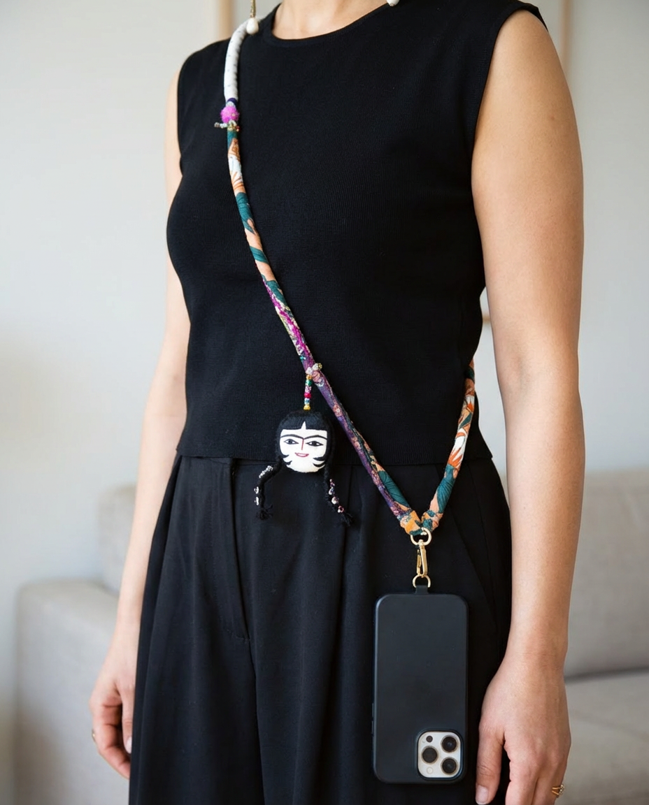 Boho crossbody phone strap worn over black dress