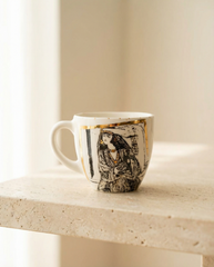 Ceramic mug with artistic design on a light surface