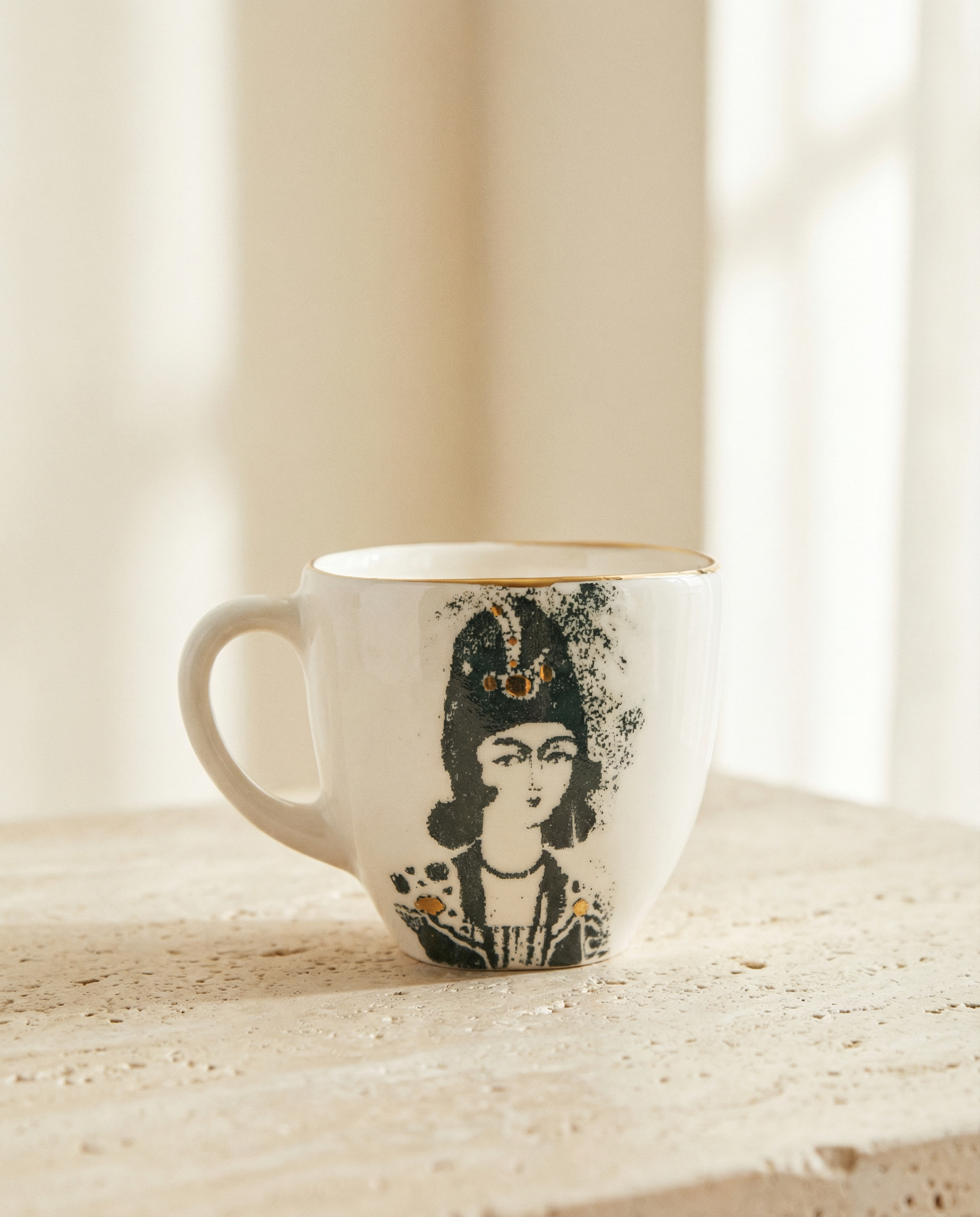 White mug with a decorative design on a wooden surface