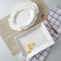 Elegant irregular white ceramic plate in Japanese style. Perfect for dim sum, modern dining, and minimalist table settings at home or events.