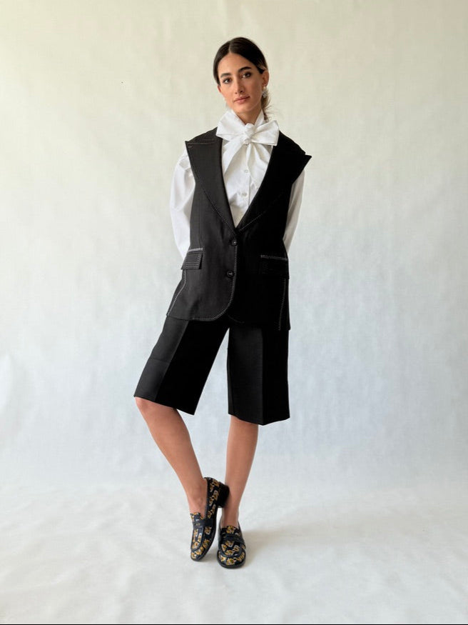 Model wearing longline sleeveless tailored vest in linen