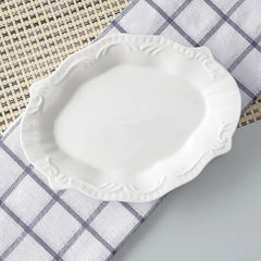 White decorative plate on a checkered tablecloth