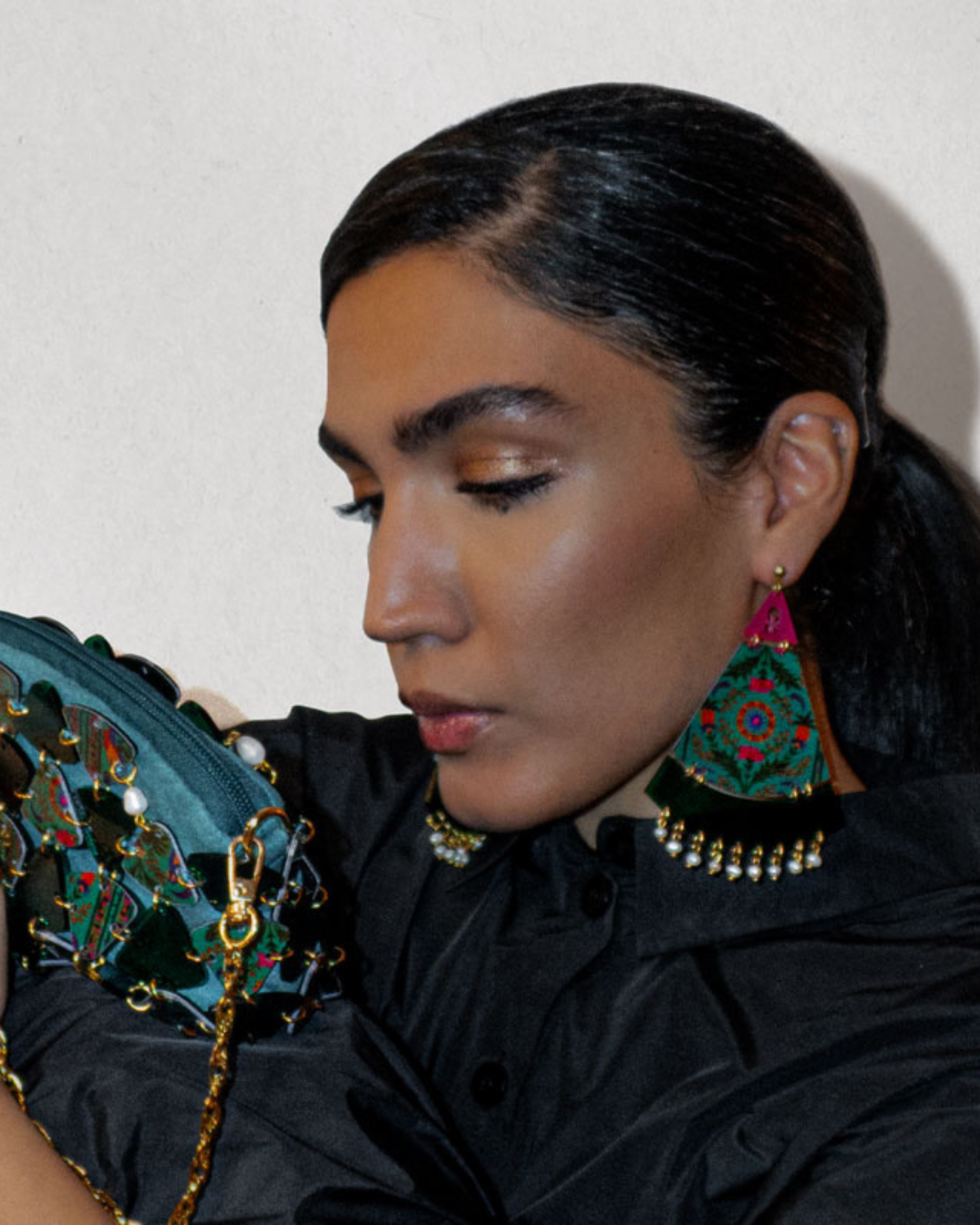 Model wearing Persian motif earrings with fan-shaped panels