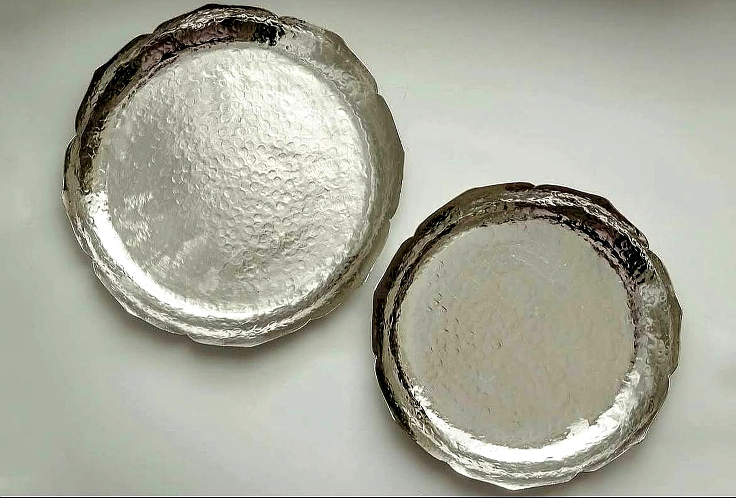 Set of scalloped-edge silver finish copper trays for home decor