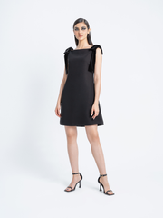 Model wearing black cocktail dress with velvet shoulder bows – Fara