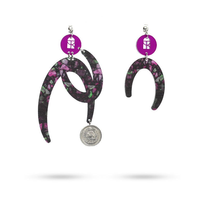 Pair of earrings with floral design and coin charm on a white background