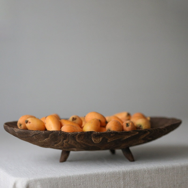 Handcrafted retro wooden fruit tray on linen tablecloth