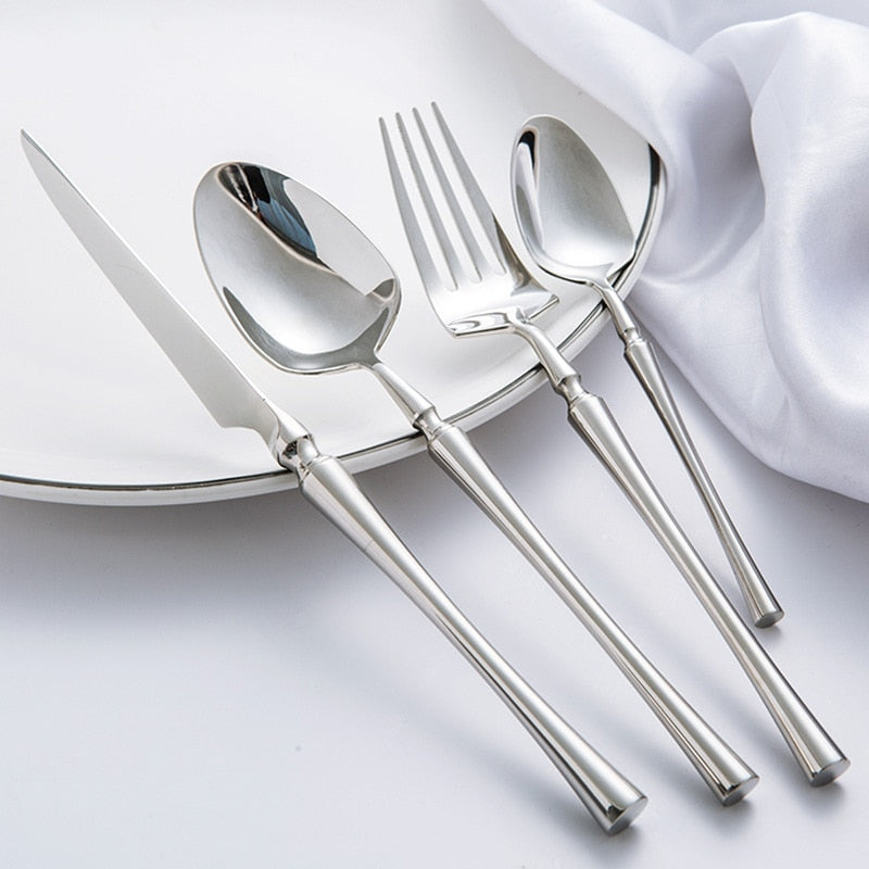 modern stainless steel cutlery set on white plate