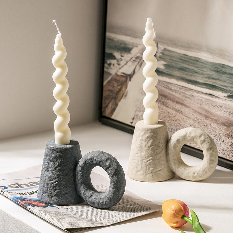 Nordic ceramic candlestick with spiral candle on white table
