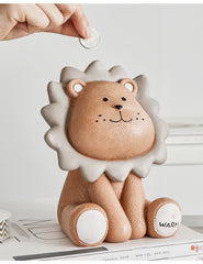 Hand placing coin in lion piggy bank
